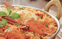Steaming chicken biryani with basmati rice and spices
