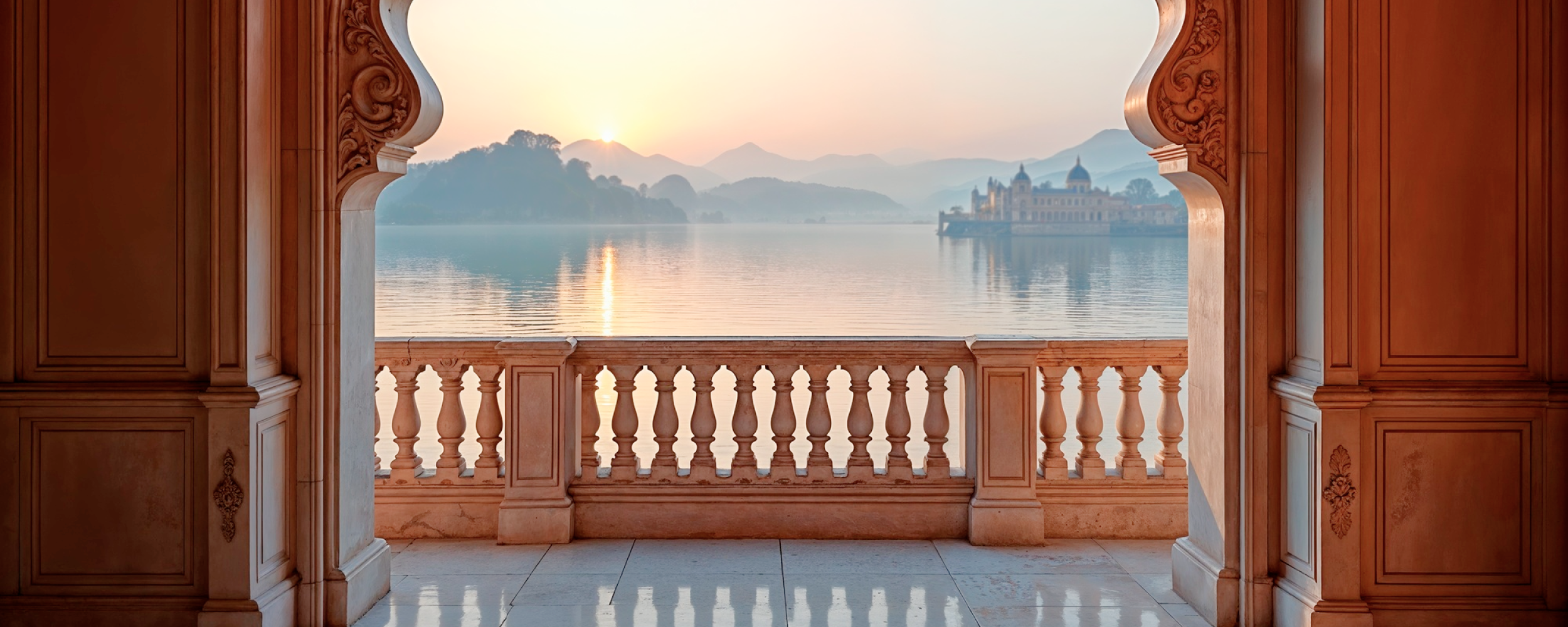 Ornate marble balcony overlooking a misty lake and palace at sunrise — one of the must visit places in India, Udaipur's Lake Palace, Rajasthan