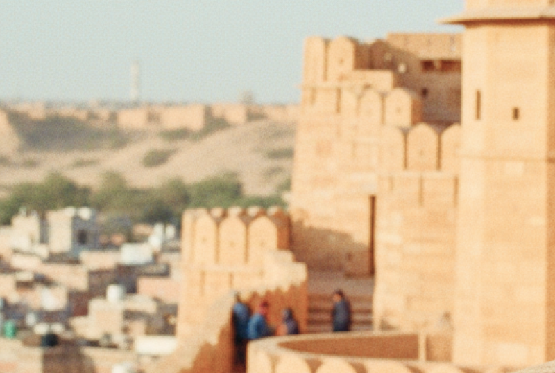 Visitors walking along the ramparts of Jaisalmer Fort, one of the most iconic historical places in India for tourists, overlooking the golden city below thumbnail