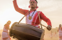 Dhol drummers and dancers in traditional red and white Assamese attire performing at the Rongali Bihu Festival of India thumbnail
