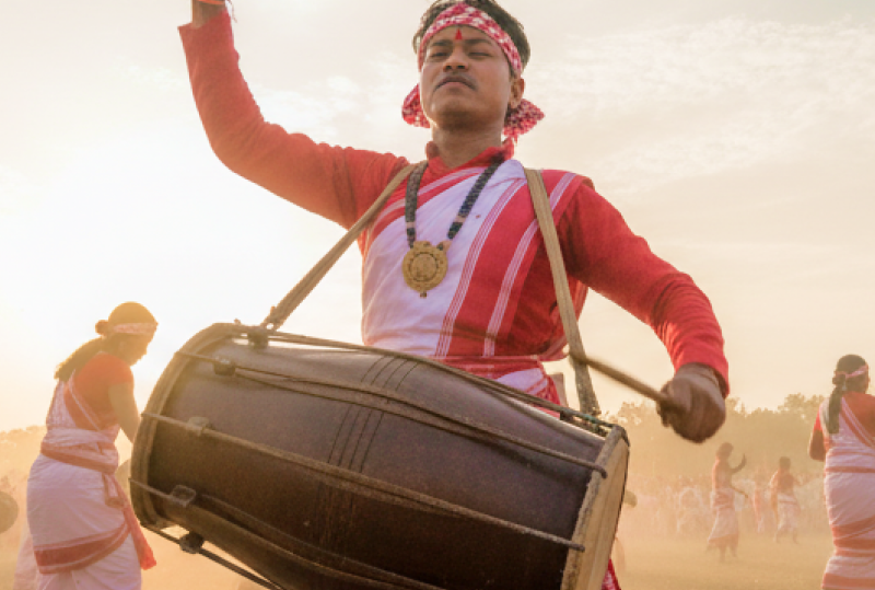 Dhol drummers and dancers in traditional red and white Assamese attire performing at the Rongali Bihu Festival of India thumbnail