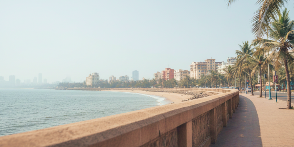 Marine Drive promenade on a Mumbai itinerary — palm lined seafront walkway with the Arabian Sea and city skyline in the background