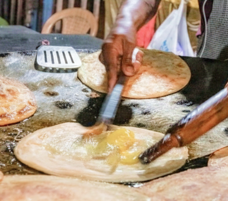 Fresh kathi rolls being cooked at a Kolkata street stall