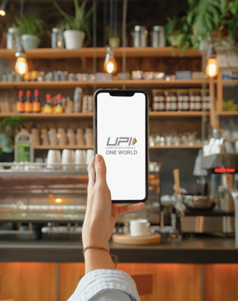 Woman Sitting at Table Holding Cell Phone thumbnail