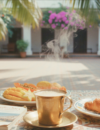 Pondicherry hotels and homestays experience — a colonial courtyard breakfast with steaming filter coffee, fresh tropical fruit, and a croissant on Athangudi tiled table thumbnail