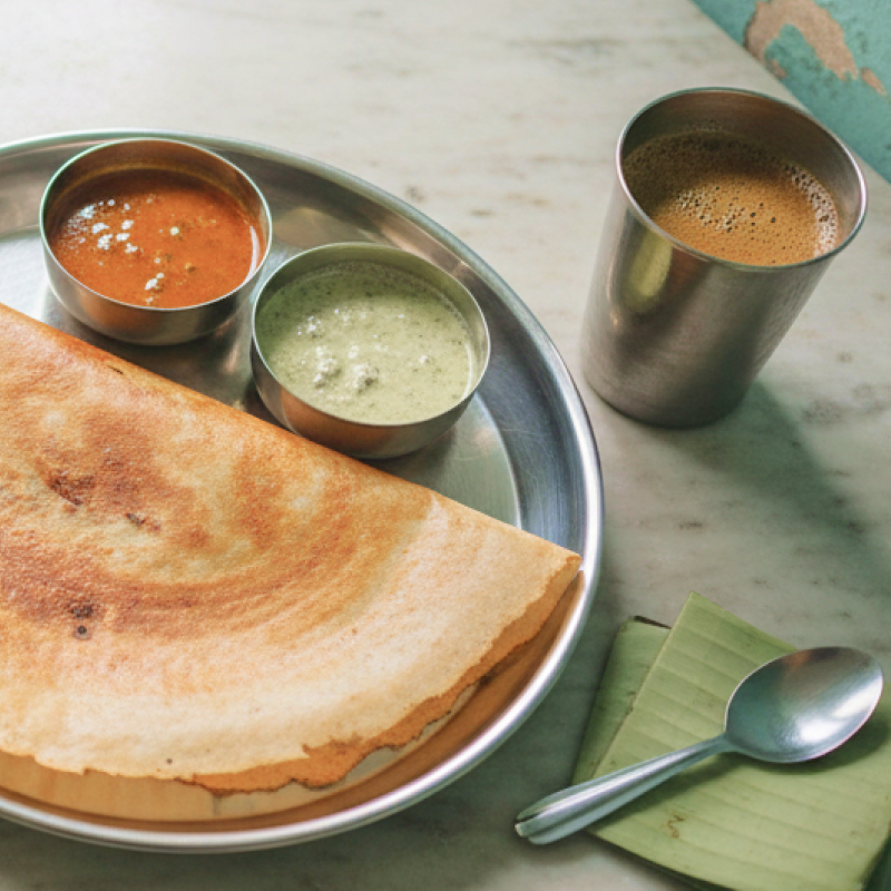 A masala dosa served in a steel thali with sambar and coconut chutney at a traditional Chennai tiffin shop, where to eat in Chennai for an authentic South Indian breakfast thumbnail