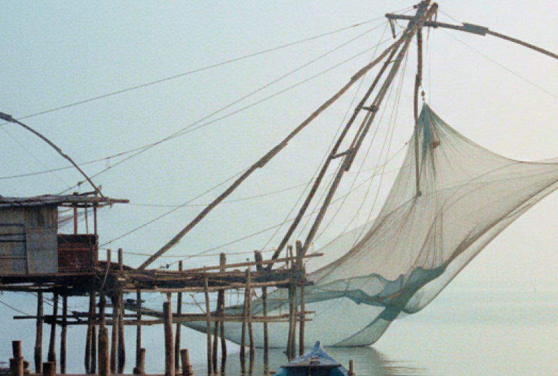 Chinese fishing nets and a weathered wooden boat on the misty Fort Kochi waterfront at dawn — a highlight of any day Kochi itinerary thumbnail