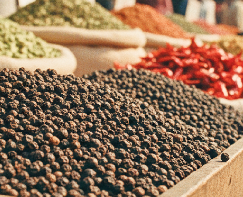 Colourful spice stalls piled with black pepper, cardamom, and dried chilli at a Kochi market — essential stops when exploring where to eat in Kochi thumbnail