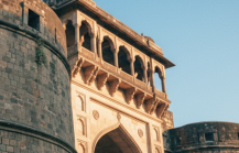 Low angle view of Shaniwar Wada's rounded bastion and colonnaded gateway at golden hour — an iconic landmark in any Pune travel guide thumbnail