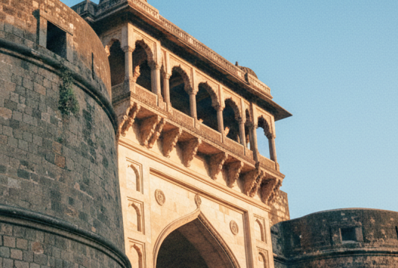 Low angle view of Shaniwar Wada's rounded bastion and colonnaded gateway at golden hour — an iconic landmark in any Pune travel guide thumbnail