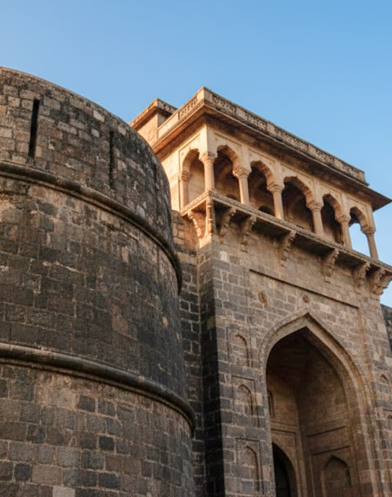 Low angle view of Shaniwar Wada's rounded bastion and colonnaded gateway at golden hour — an iconic landmark in any Pune travel guide thumbnail