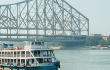 Passenger ferries moored on the Hooghly River with Howrah Bridge in the background, Kolkata travel guide thumbnail