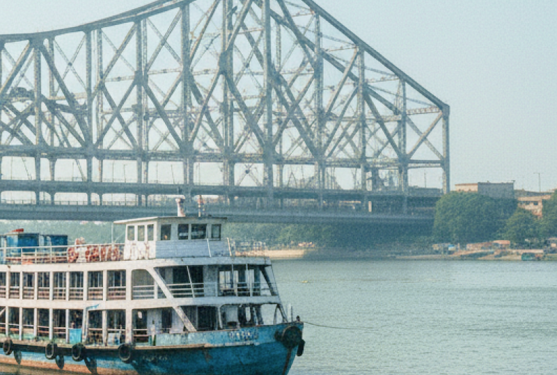 Passenger ferries moored on the Hooghly River with Howrah Bridge in the background, Kolkata travel guide thumbnail