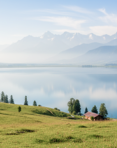 Panoramic view of a serene alpine lake surrounded by snow capped mountains and green meadows — Kashmir travel guide thumbnail