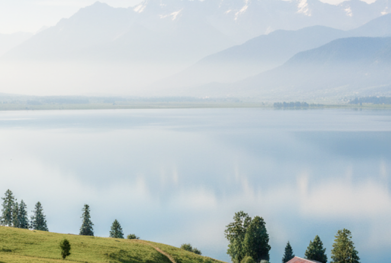 Panoramic view of a serene alpine lake surrounded by snow capped mountains and green meadows — Kashmir travel guide thumbnail